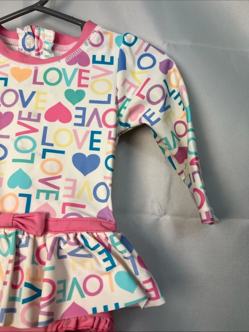 Ruffle Butts pink Love print ruffle bottom one piece rash guard swim-flaw